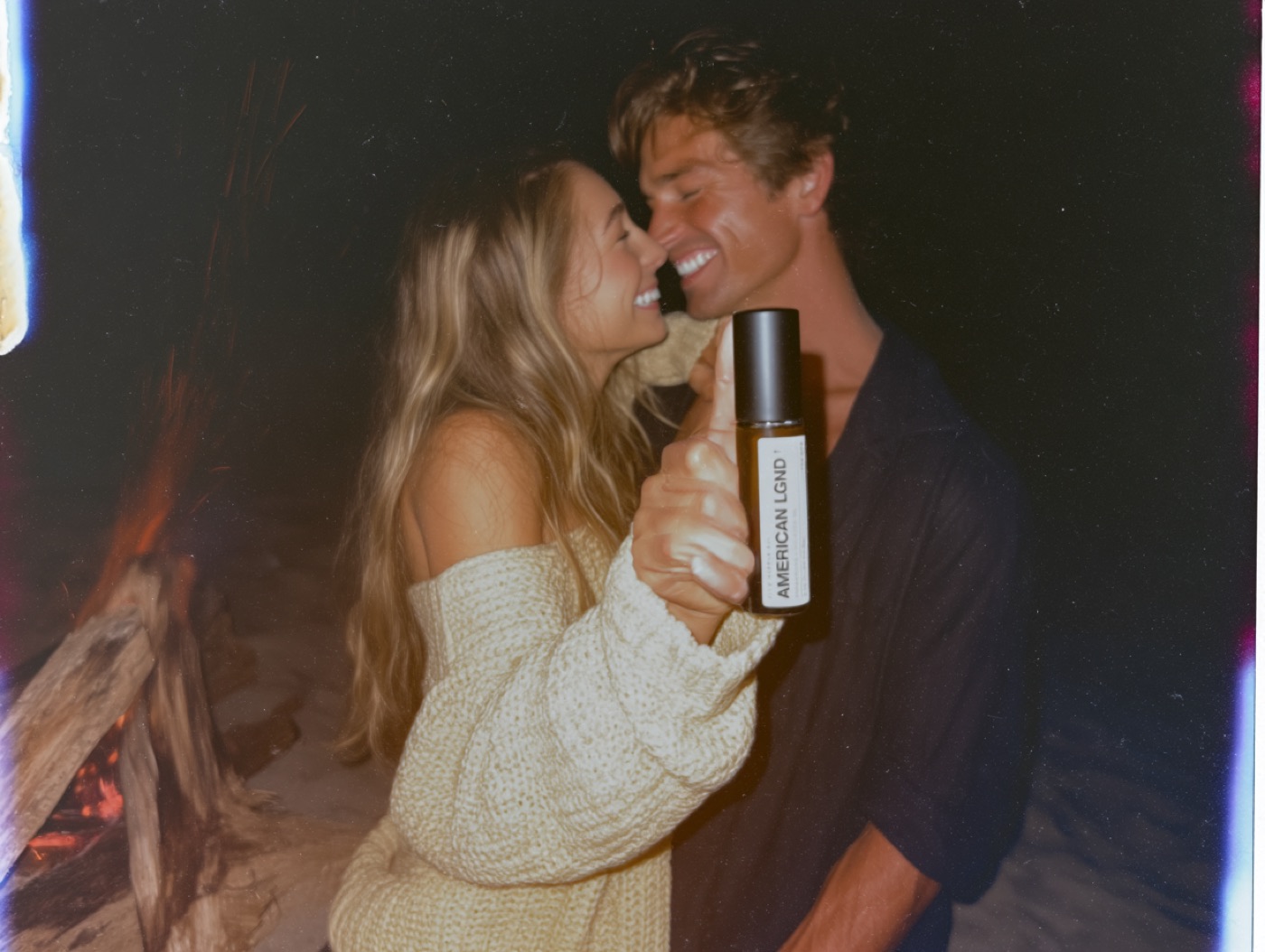 Couple close together by firelight